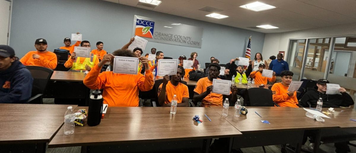 a group of men holding up certificates of completion