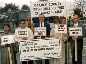 a group of people holding a giant check